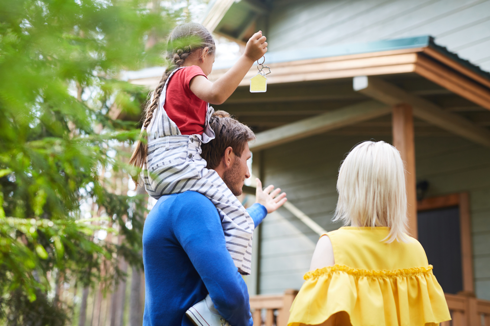 family of three arriving at cabin