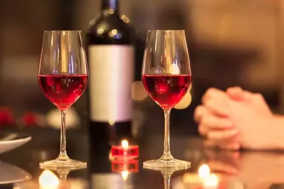 two wine glasses sitting on table in romantic restaurant