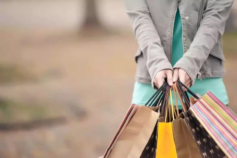 woman holding bags from all the shops in pigeon forge