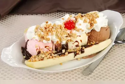 A delicious banana split ice cream sundae.