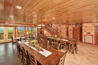 Long tables in the dining area of a large group cabin in Gatlinburg TN.