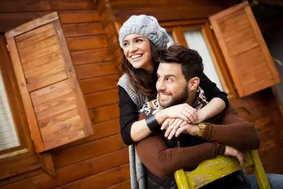 A happy couple at a cabin.