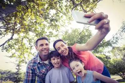 A family taking a selfie in nature.