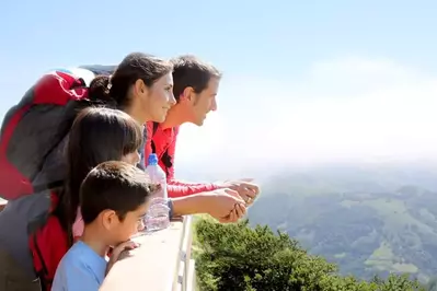 Happy family enjoying scenic views of the mountains.