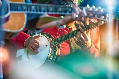 A banjo and a guitar being played on stage.