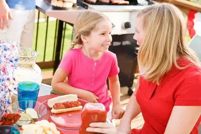 Mother and daughter at a cookout on the deck.