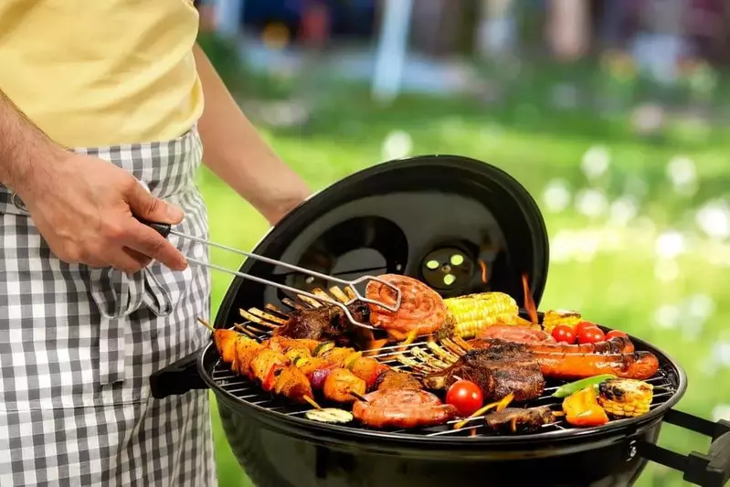 A man grilling meats and vegetables at one of our Pigeon Forge rental cabins.