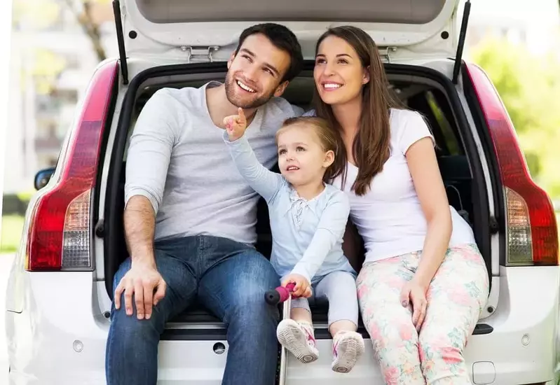 Happy family sitting in the boot of their car near our luxury vacation rentals in Pigeon Forge TN.