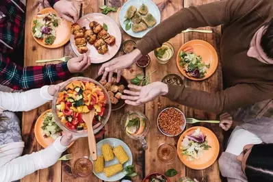 A group of friends sharing lots of food.