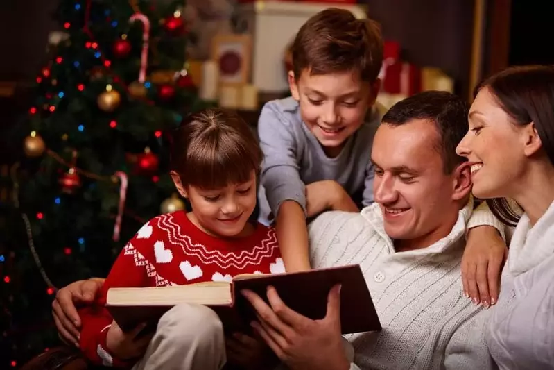 Family reading a holiday story together at our Smoky Mountain Christmas cabin rentals.