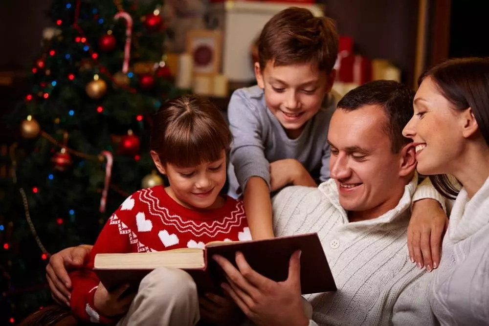 Family reading a holiday story together at our Smoky Mountain Christmas cabin rentals.