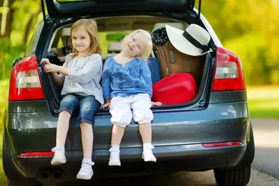 family in car headed to Pigeon Forge Cabin Rentals Close To Parkway