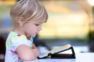 little girl looking at pictures of cabins in Gatlinburg TN