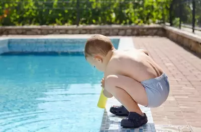 kid wearing water shoes in a Gatlinburb cabin with indoor pool