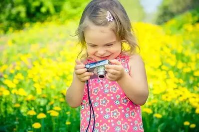 little girl taking photos during a Galtinburg family vacation