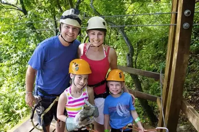 Happy family ziplining in the Smoky Mountains.