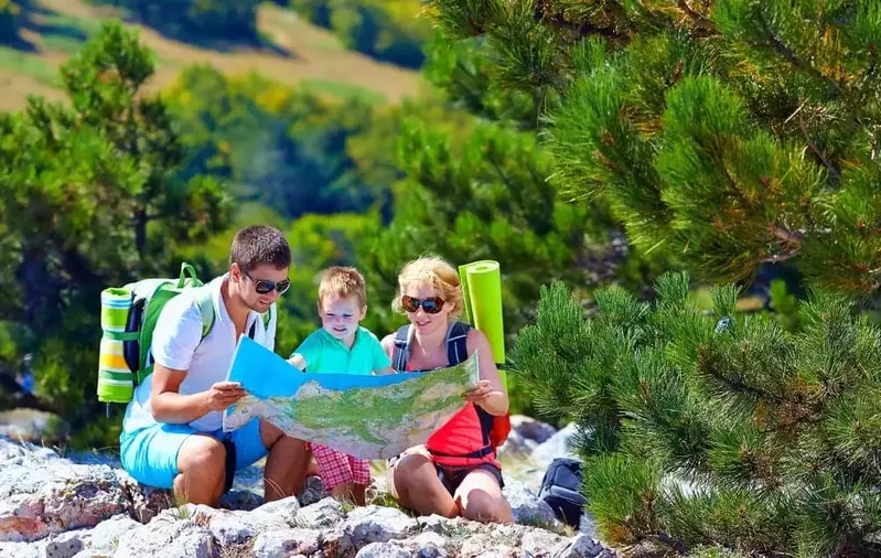 Family checking a map in the Smoky Mountains near their 2 bedroom Gatlinburg cabin.