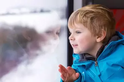 child enjoying a rainy day inside an affordable Galtinburg cabin