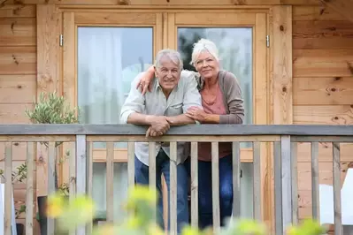 Mature couple smiling from a Gatlinburg cabin deck