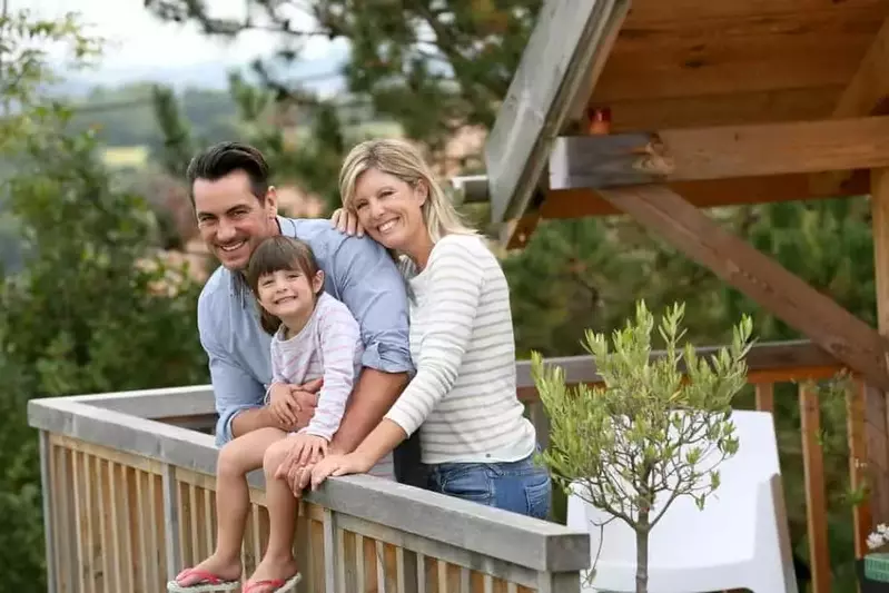 Family standing outside a Gatlinburg cabin rental in the springtime