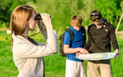 Family of three looking at a map to take a hike in the Great Smoky Mountains