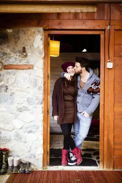 Couple standing in the doorway of a cabin