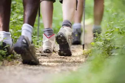 Men and women boots hiking on a trail