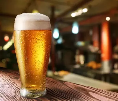 Light beer on wooden table