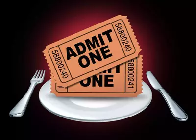 Two "admit one" tickets on top of dinner plate